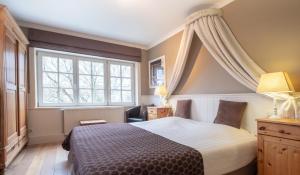 a bedroom with a large bed and a window at Gasthof Groenhove in Bruges