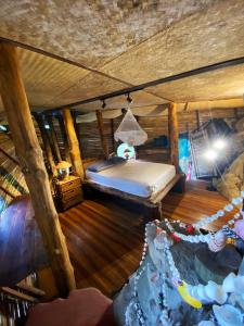 a bedroom with a bed in a log cabin at Sea View Palm Villa - Tree House in Haad Yao