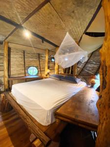 a bed in a room in a tree house at Sea View Palm Villa - Tree House in Haad Yao