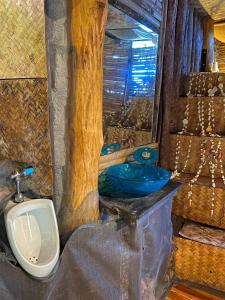 a bathroom with a sink and a toilet and a urinal at Sea View Palm Villa - Tree House in Haad Yao