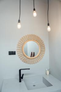 a bathroom with a mirror and a sink at HIMA Bungalows in Lagudri