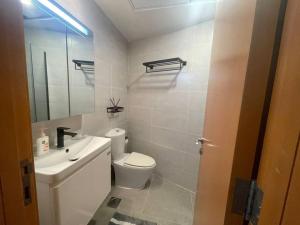 a bathroom with a white toilet and a sink at 2-bedroom & 3 bath in Dubai Marina & 5 min walking to JBR in Dubai