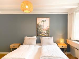 a bedroom with a large bed with white sheets at Family-Friendly Flat Near Tivoli Gardens in Copenhagen