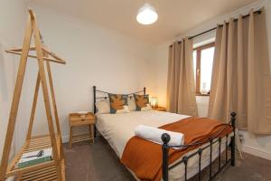 a bedroom with a bed with a wooden frame at Parf’s Place, Troedyrhiw near Bike Park Wales in Troed-y-rhiw