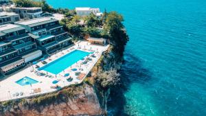 an aerial view of a resort on the edge of the water at Aqua Holiday Apartments in Vlorë