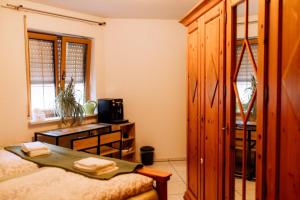 a bedroom with a bed and a cabinet and a table at Moderne Landwohnung - Pension - Top Lage in Gottmadingen