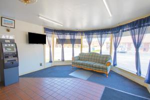 a living room with a couch and a television at Centralia Motel near Downtown by OYO in Centralia