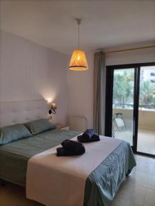 a bedroom with a bed with two towels on it at Morello 1A in Calpe