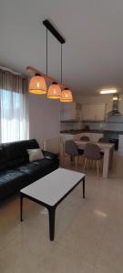 a living room with a black couch and a table at Morello 1A in Calpe