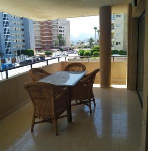 a table and chairs on a balcony with a view of a city at Morello 1A in Calpe