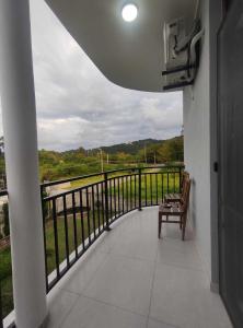 a balcony with a bench and a view of a river at The best guest house-GAIOZ in Gonio