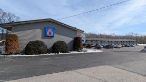 a building with a sign on it in a parking lot at Motel 6-Leominster, MA in Leominster