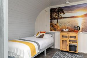 a bedroom with a bed and a painting on the wall at Broom Leisure in Annan