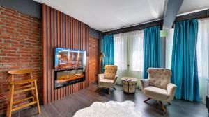 a living room with two chairs and a fireplace at Wonder Wood Hotel in Istanbul