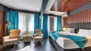 a bedroom with a bed and two chairs at Wonder Wood Hotel in Istanbul