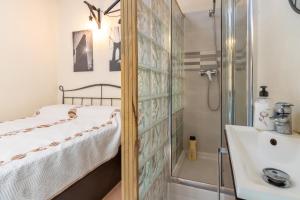 a bedroom with a shower and a bed and a sink at Duna in Palamós