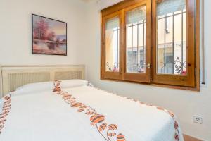 a bedroom with a bed and a window at Dana in Palamós