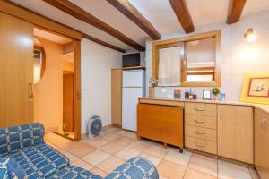 a kitchen with a counter and a refrigerator at Dana in Palamós