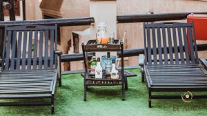 zwei Stühle auf dem Rasen mit Getränken auf dem Tisch in der Unterkunft El Aura l Complejo de apartamentos amoblados in Villa Krause