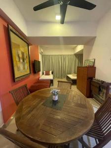 a dining room with a wooden table and a living room at SGA SuriaJelutong in Shah Alam