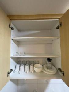 a cupboard with some dishes and bowls on it at SGA SuriaJelutong in Shah Alam