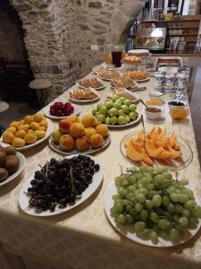 a table with many plates of fruit on it at La Casa della Filanda in Belmonte Calabro