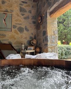 a bed in a room next to a body of water at BoisBolchet Ecolodge-SPA in Bouillargues