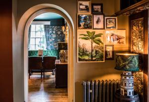 an archway in a room with pictures on the wall at The Knaresborough Inn - The Inn Collection Group in Knaresborough