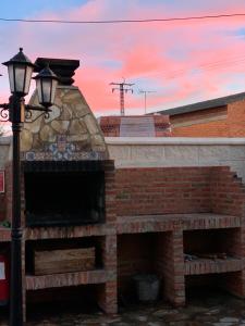 a brick fireplace with a street light and a sunset at Casa Rural Alaejos in Alaejos
