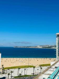 a view of a beach and the ocean at Luxueux Appartement centre et plage & wifi ! in Tangier