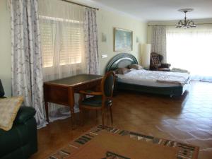 a bedroom with a desk and a bed and a desk at Apartments in a "VILLA VISTA JAVEA" in Jávea
