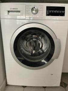 a white washing machine with its door open at Batumi Sea View in Batumi