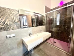 a bathroom with a sink and a mirror at Sealovers house Sea view Deluxe in Civitavecchia