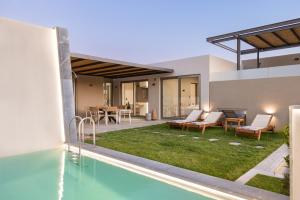 a view of a house with a swimming pool and a backyard at New Modern Villa Domus Myrtia with private pool & BBQ, 4km from nearest beach in Marioú