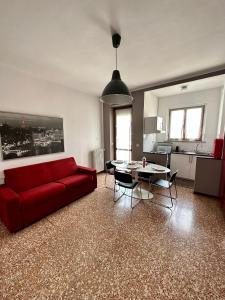 a living room with a red couch and a table at Casa Voli in Turin
