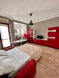 a bedroom with red cabinets and a large bed at Casa Voli in Turin