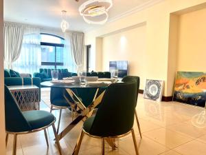 a dining room with a table and chairs at 2Bedroom Palm Jumeirah luxury Stay At Golden Mile 10 in Dubai