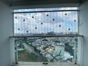 a view of a city through a glass window at Spacious Apartment with 3-bedroom in District 7 in Ho Chi Minh City
