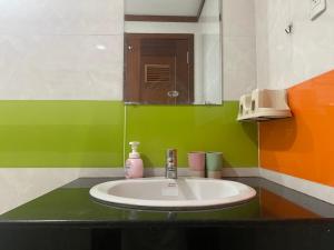 a bathroom with a sink and a mirror at Spacious Apartment with 3-bedroom in District 7 in Ho Chi Minh City