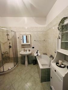 a bathroom with a sink and a shower and a tub at Bellavista Bobbio in Bobbio +3 photos