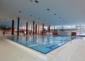 a large swimming pool in a large building at Old Town Museum Apartment in Liberec