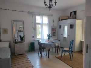 a dining room with a table and chairs at Willa Gaszek in Inowłódz +11 photos