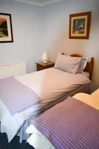 A bed or beds in a room at Simply Donegal Adrihidbeg Cottage