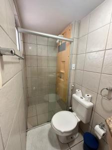a small bathroom with a toilet and a shower at Terrazzo Ponta Negra Flat in Natal