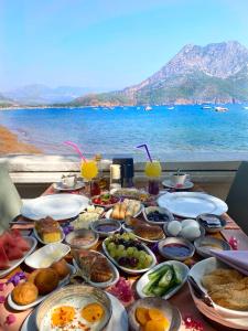a table full of food with a view of the ocean at Ford Hotel in Adrasan