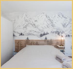 a bedroom with a mountain mural on the wall at Appartement T2 Moderne Neuf Collonge in Collonges-sous-Salève