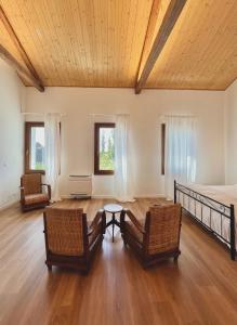 a bedroom with a bed and two chairs and a table at Agriturismo Borgo Rurale San Salvador-Casa del Maestro in Torre di Mosto +61 photos