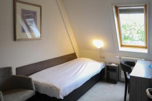 Postel nebo postele na pokoji v ubytování Golden Tulip Ampt van Nijkerk