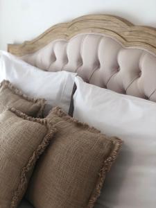 a bed with white pillows at Villa Rafa in Costa Nova