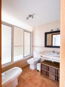 uma casa de banho com um WC, um lavatório e um espelho. em Laguna Home by Best Holidays Fuerteventura em Corralejo